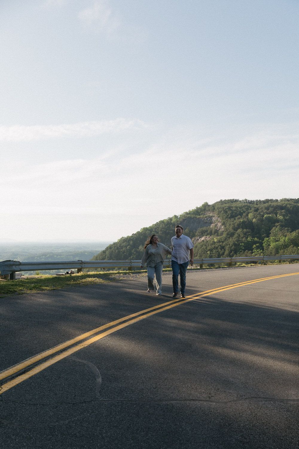 Western engagement photo of couple wearing cowboy hats and boots