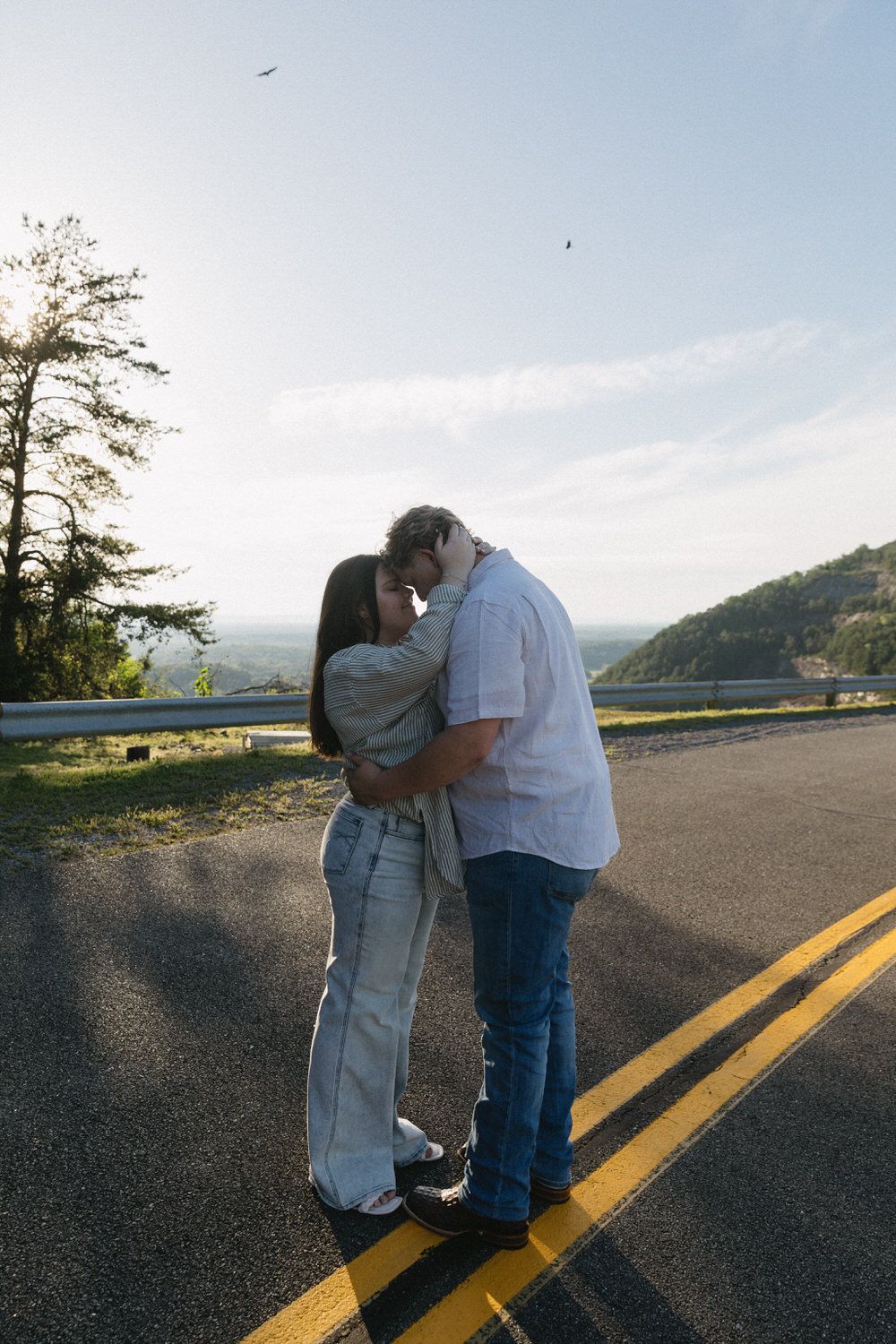 a couple touches nose to nose in western inspired attire at their North Georgia engagement session
