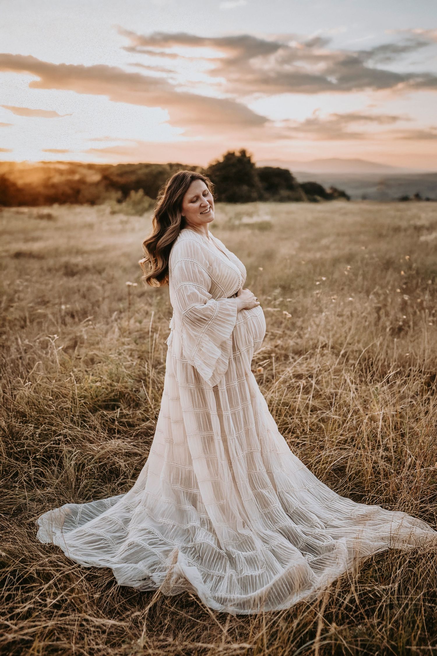 Magical Golden Hour Maternity Photos at Lewisville Lake of a mother embracing her belly in the setting sun