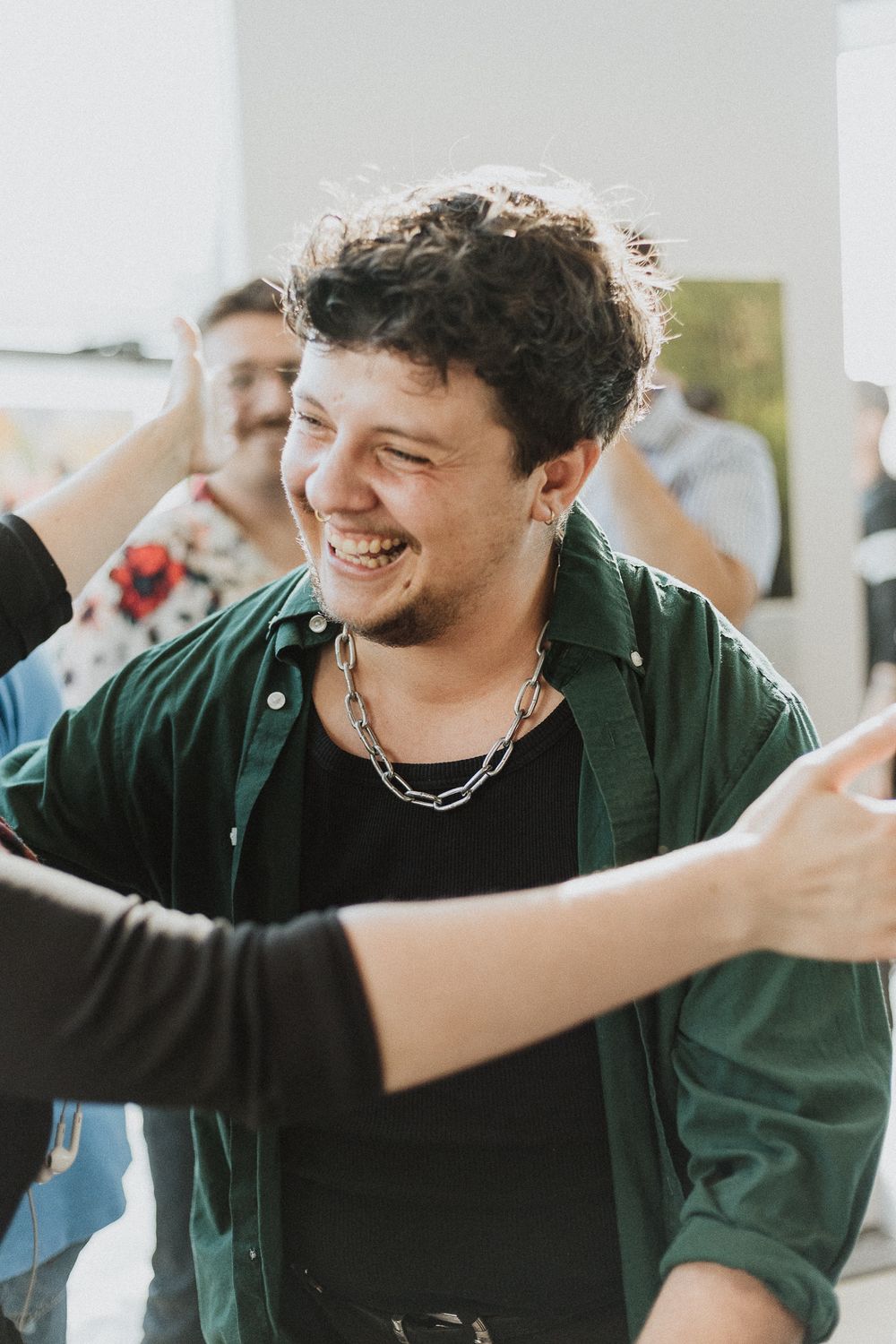 A candid outdoor scene shows a joyful gathering of friends sharing laughter in natural lighting.