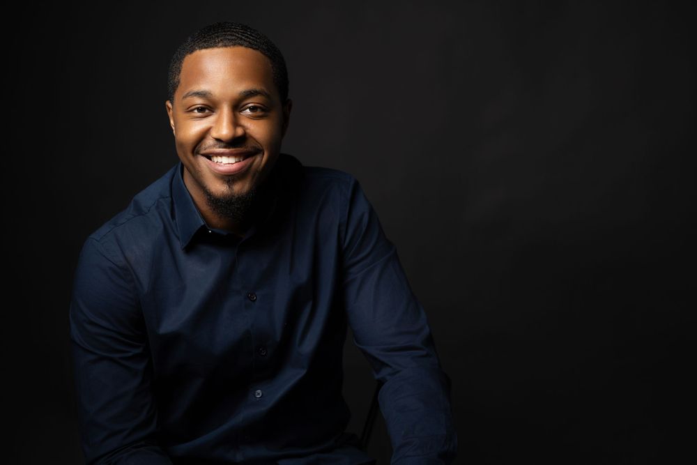 Studio portraits in dark lighting showing different angles and expressions.
