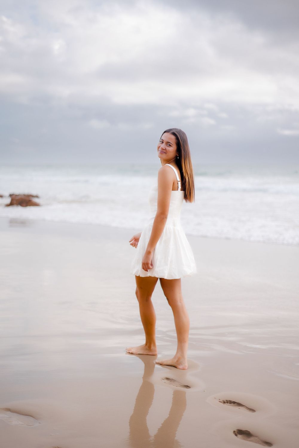 portrait of daughter during photoshoot on a cloudy beach at Coolum, Sunshine Coast, in soft morning light with blues, purples and pinks