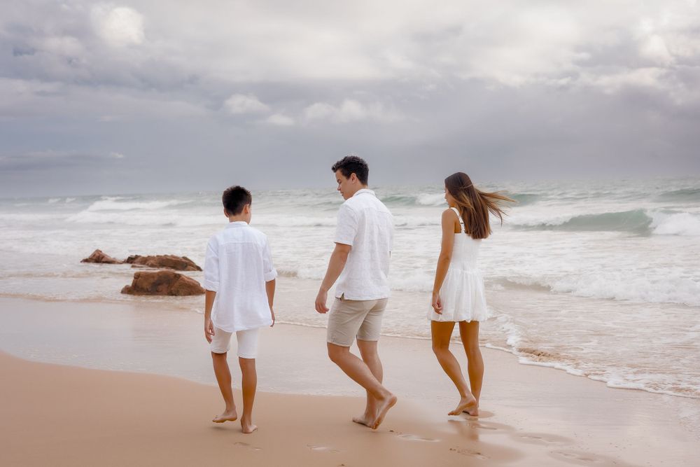 Family photoshoot on a cloudy beach at Coolum, Sunshine Coast, capturing the family together in soft morning light