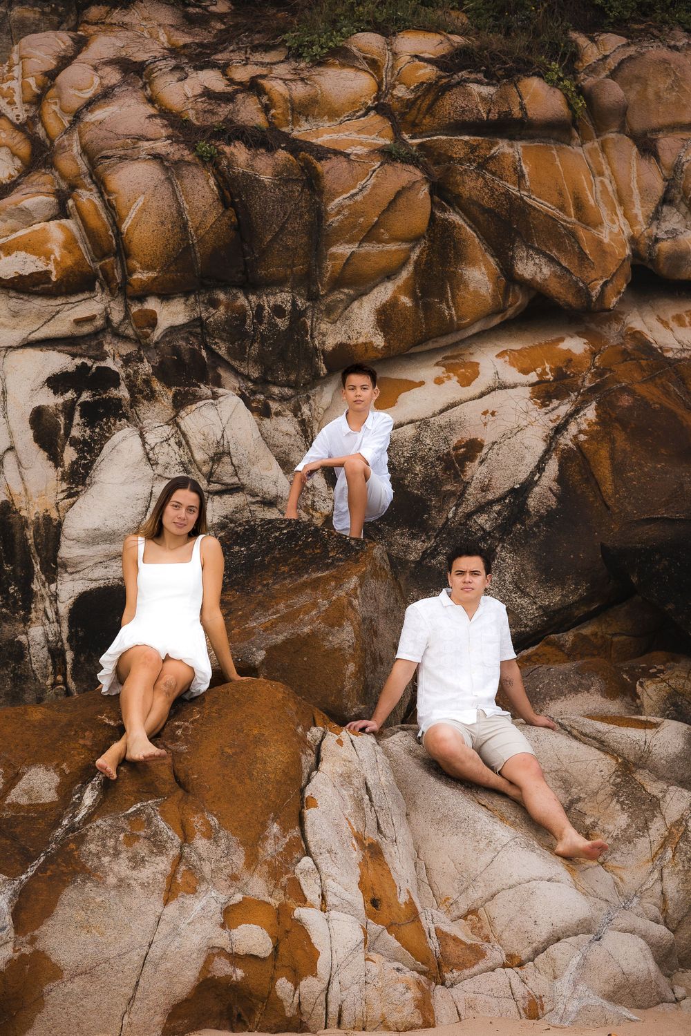 Family photoshoot on the cliffs at Coolum beach, Sunshine Coast, capturing the family together in soft golden morning light