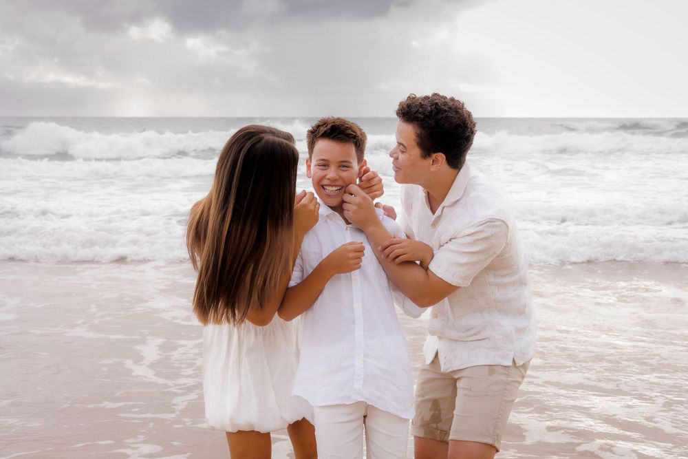 Early morning family photoshoot at Coolum Beach, on the sunshine coast capturing soft light and serene ocean views