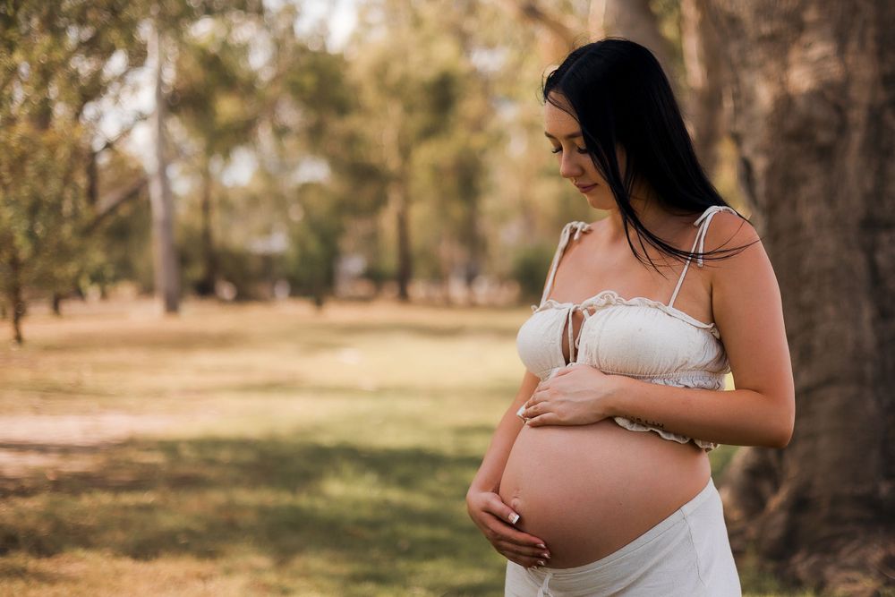 Beautiful maternity photoshoot in with baby bump with natural sunlight in the South Burnett during Golden Hour