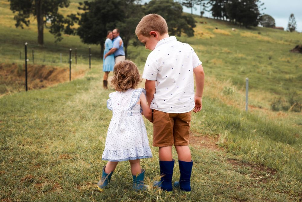 candid photo of toddlers on a farm in Gympie after a storm, capturing a beautiful and sweet moment in nature during photoshoot