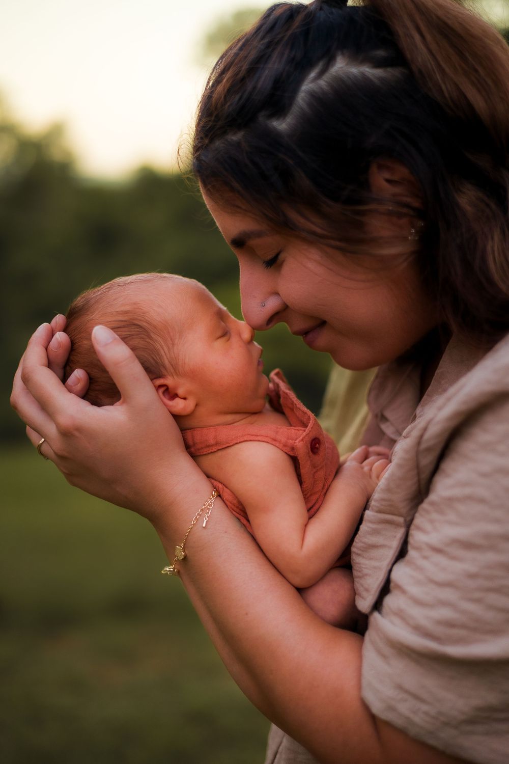 Newborn photo session with mum and baby lovingly embrace in the Sunshine Coast hinterland at dusk