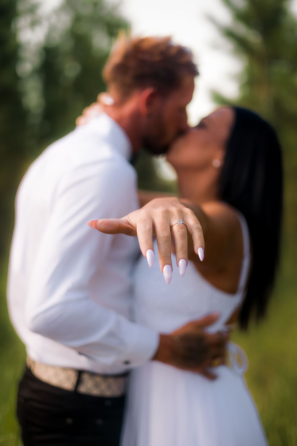 Engagement photography session with couple kissing and showing off engagement ring in beerwah forest on the Sunshine Coast at sunset