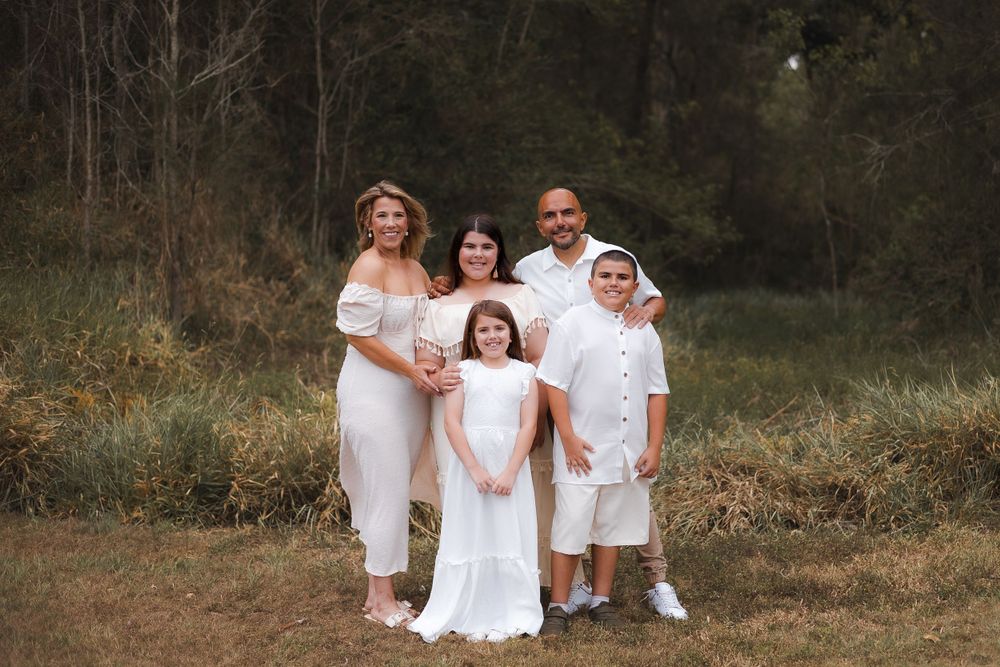 Fun family photoshoot at Lake Samsonvale, Joyner, showcasing candid moments of laughter and connection by the greenery