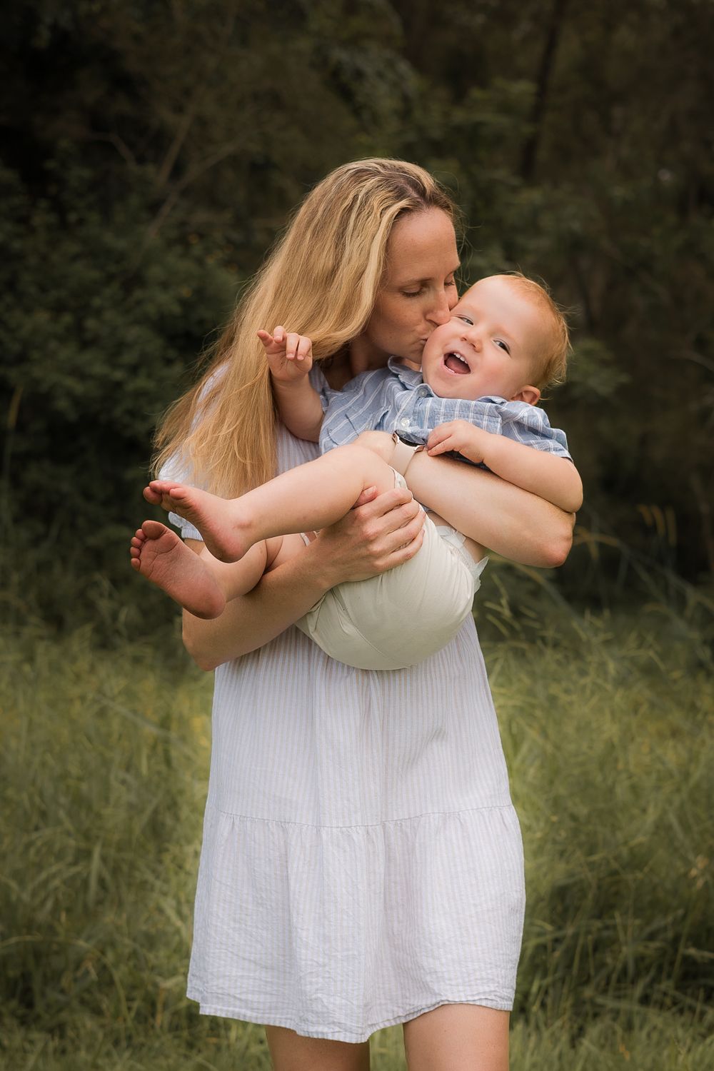 Family laughing and playing together during a candid outdoor photoshoot on the Brisbane Northside