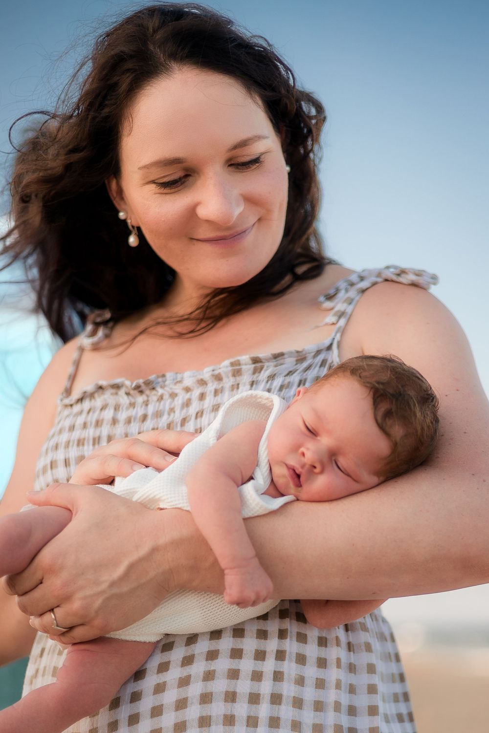 Newborn photoshoot on the beach at sunset in the Sunshine Coast