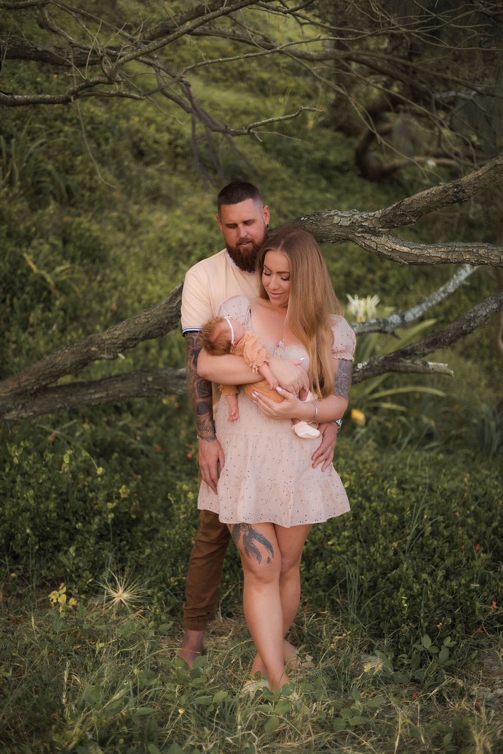 lifestyle newborn photoshoot at Sunshine Beach, Sunshine Coast, with parents lovingly interacting with their baby in soft natural light