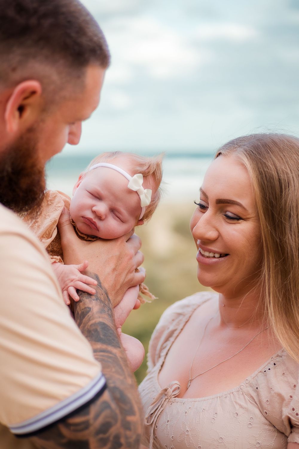 Newborn session at Sunshine Beach, Sunshine Coast, showcasing a loving family of parents and their newborn in a relaxed lifestyle shoot