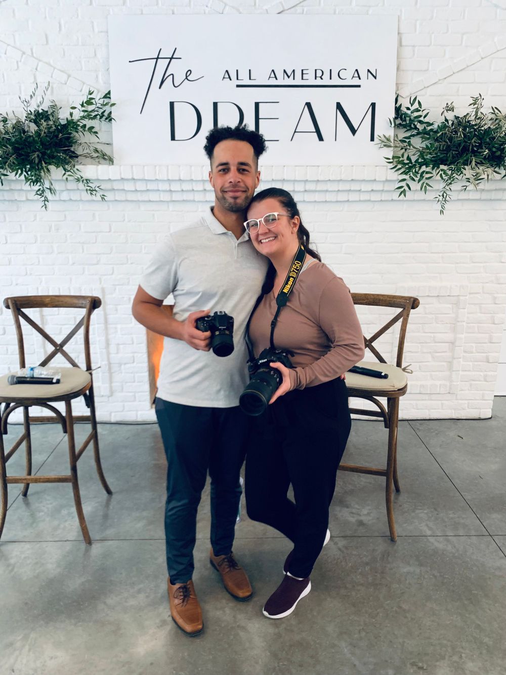 man and woman posing with camera at a photography event in minneapolis
