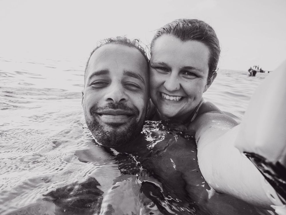 black and white photo of a man and a woman in the ocean in montego bay jamaica. photo was taken using olympus tough