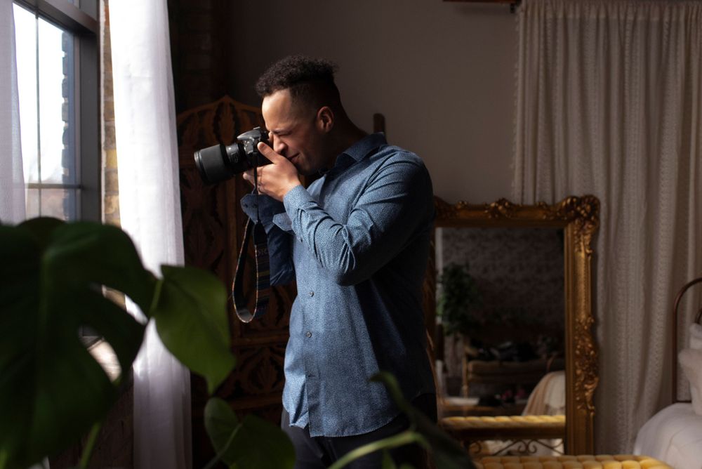 headshot of male photographer holding camera in northeast minneapolis minnesota