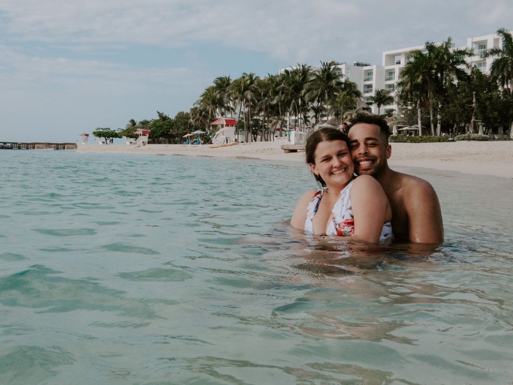 man and woman smiling in the ocean at doctors cave in montego bay jamaica