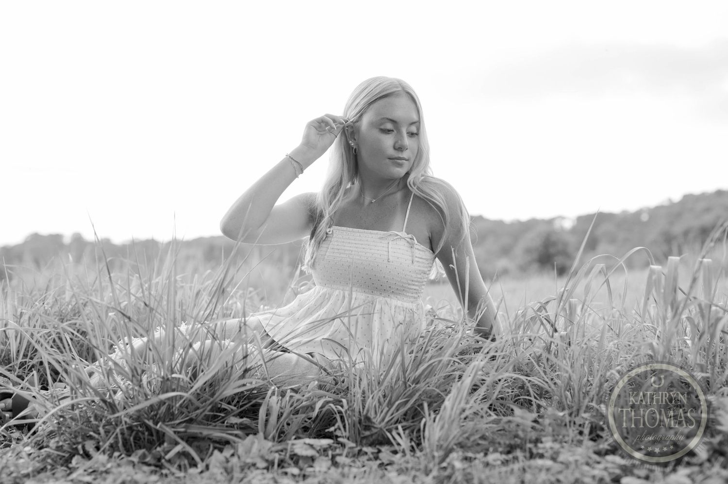 Dreamy black and white portrait in a rural field setting.