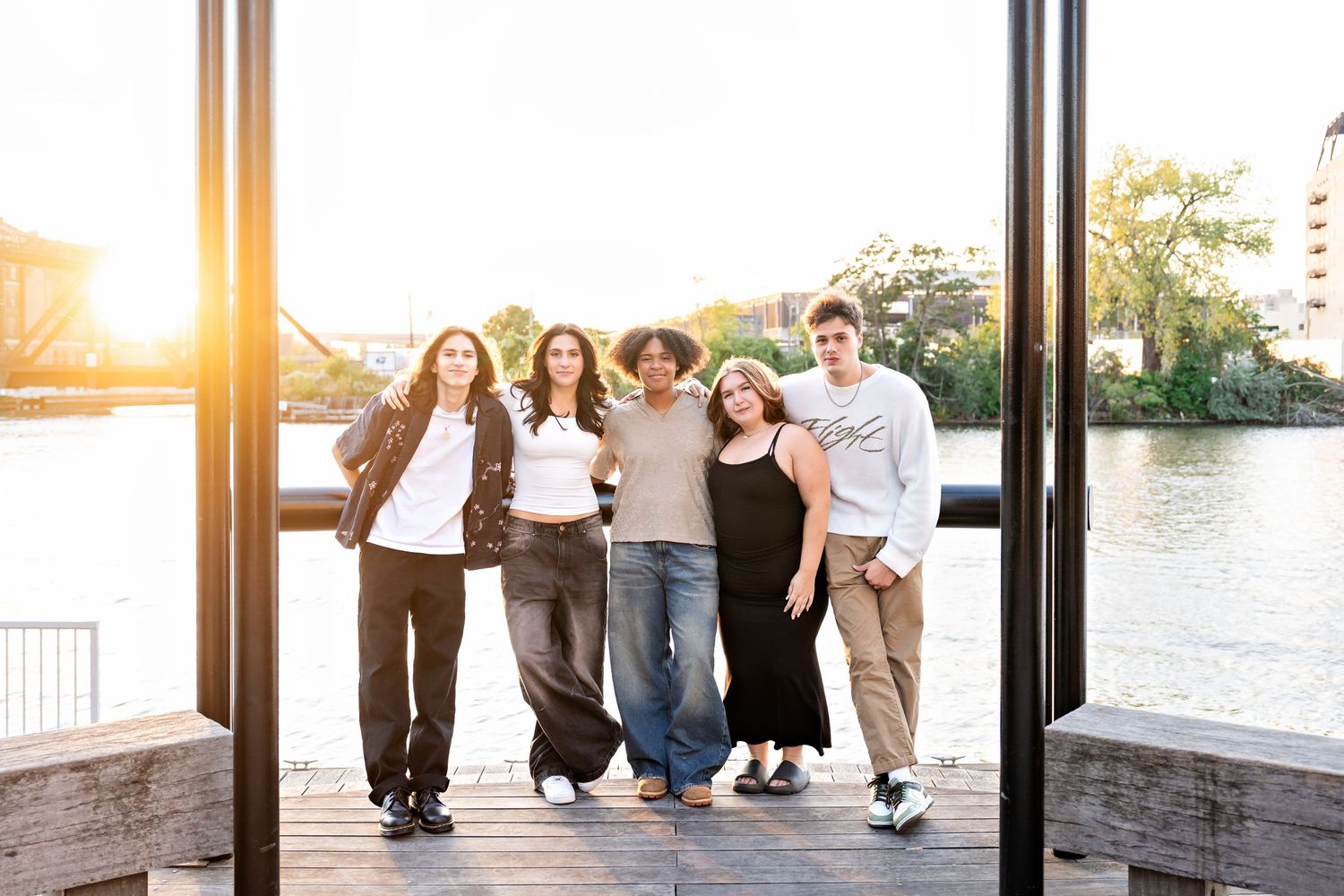 Photo of a group of senior friends taken on the Riverwalk by Milwaukee senior photographer Rachel Dickman.