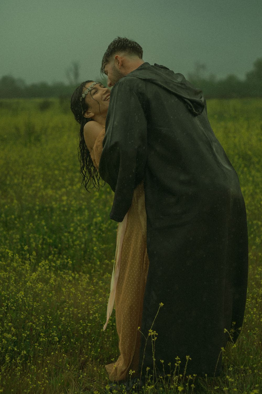Couple dancing together in a field of flowers in Southern California.