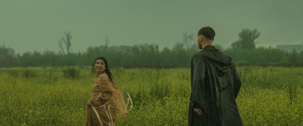 Romantic couple running through a field of flowers in the rain in Los Angeles, California.