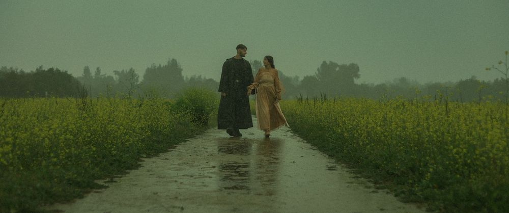 Star Wars Couple walking together on a path through misty yellow rapeseed fields during a moody, overcast day in Los Angeles.