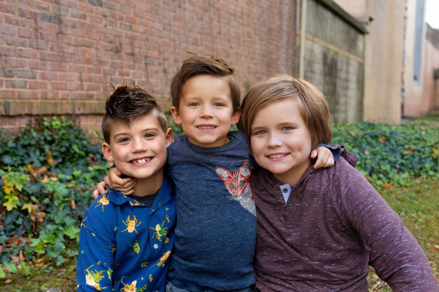 Three brothers embracing and smiling in Worthington, Ohio by Jamie Macey Photography