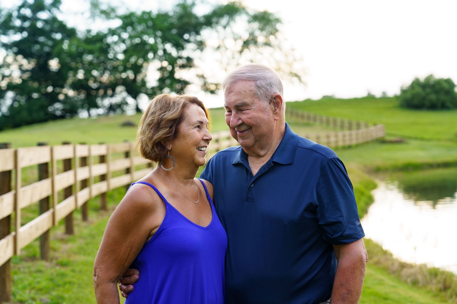 Grandparents portrait by a lake on a family property in Wooster, Ohio, by Jamie Macey Photography