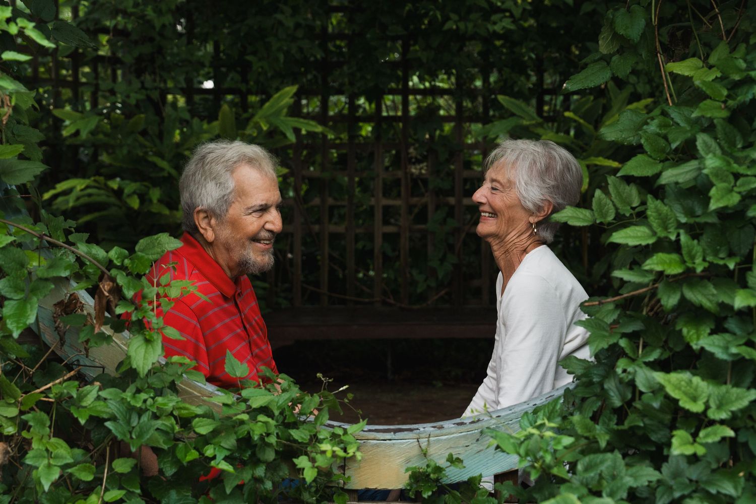 Grandparents holding hands and smiling at each other at Inniswood Metro Gardens in Westerville, Ohio, by Jamie Macey Photography