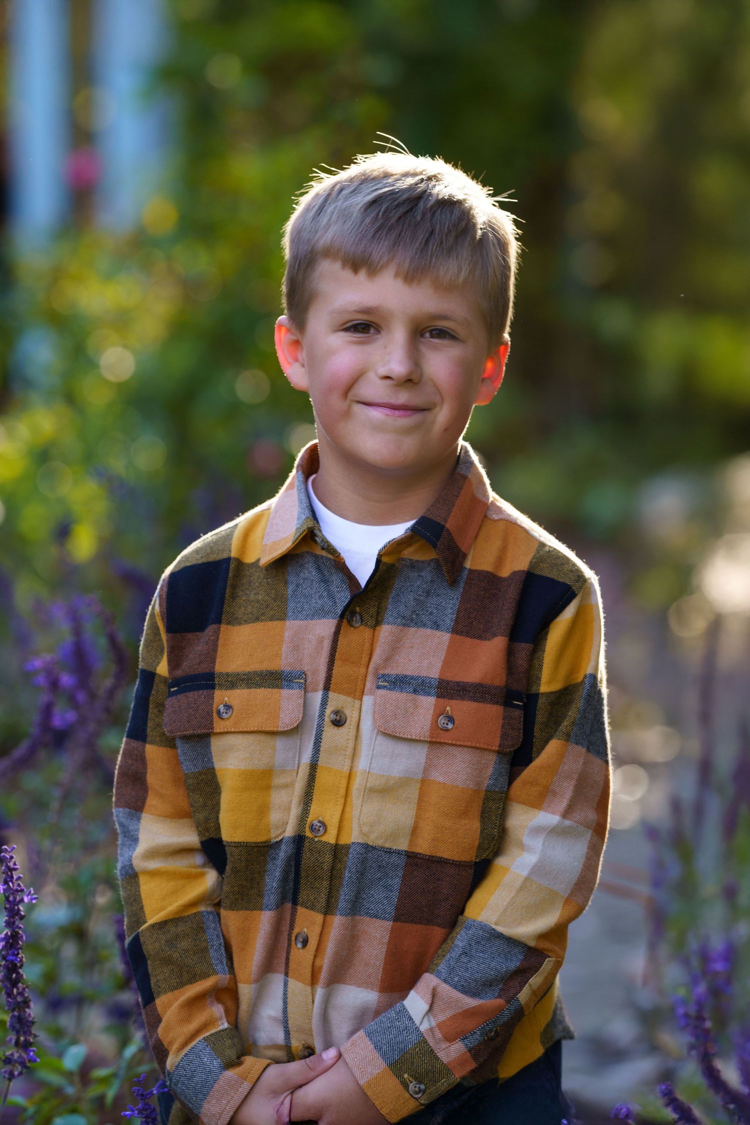 Close up of child soft smiling surround by fall foliage at Inniswood Metro Garden in Westerville, Ohio, by Jamie Macey Photography