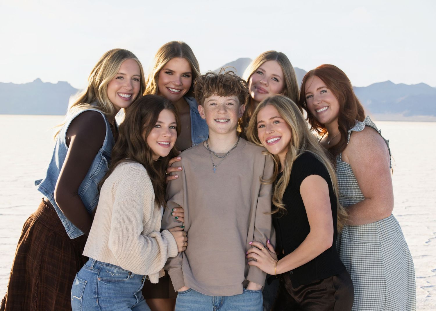 Salt Lake City Family Photographer - A group of friends pose together outdoors against the bonneville salt flats in utah