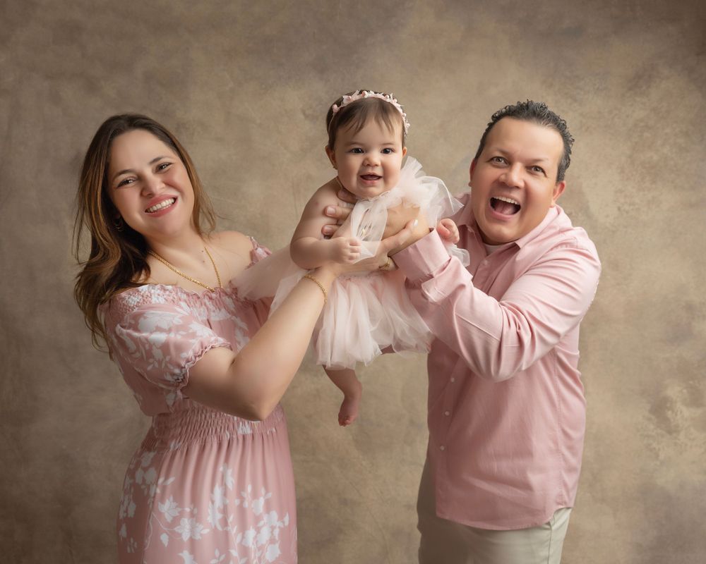 Candid family photo series showing playful moments in matching pink attire.