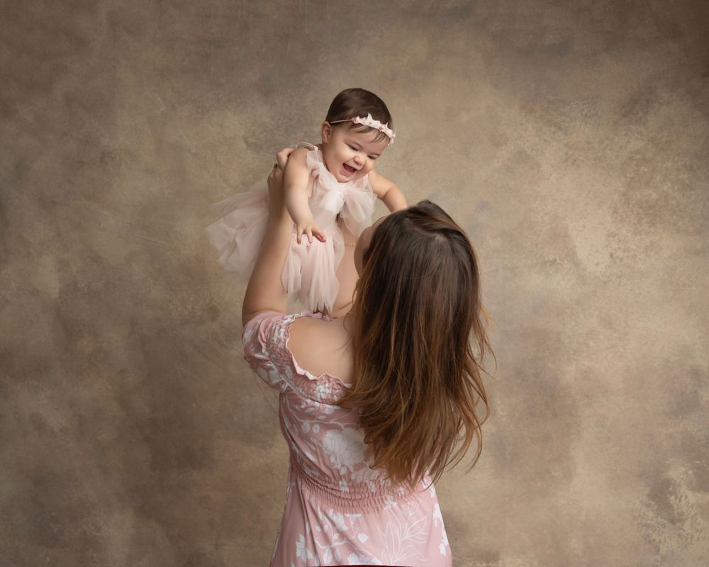 Sweet family interaction captured in a sequence of natural moments against brown backdrop.