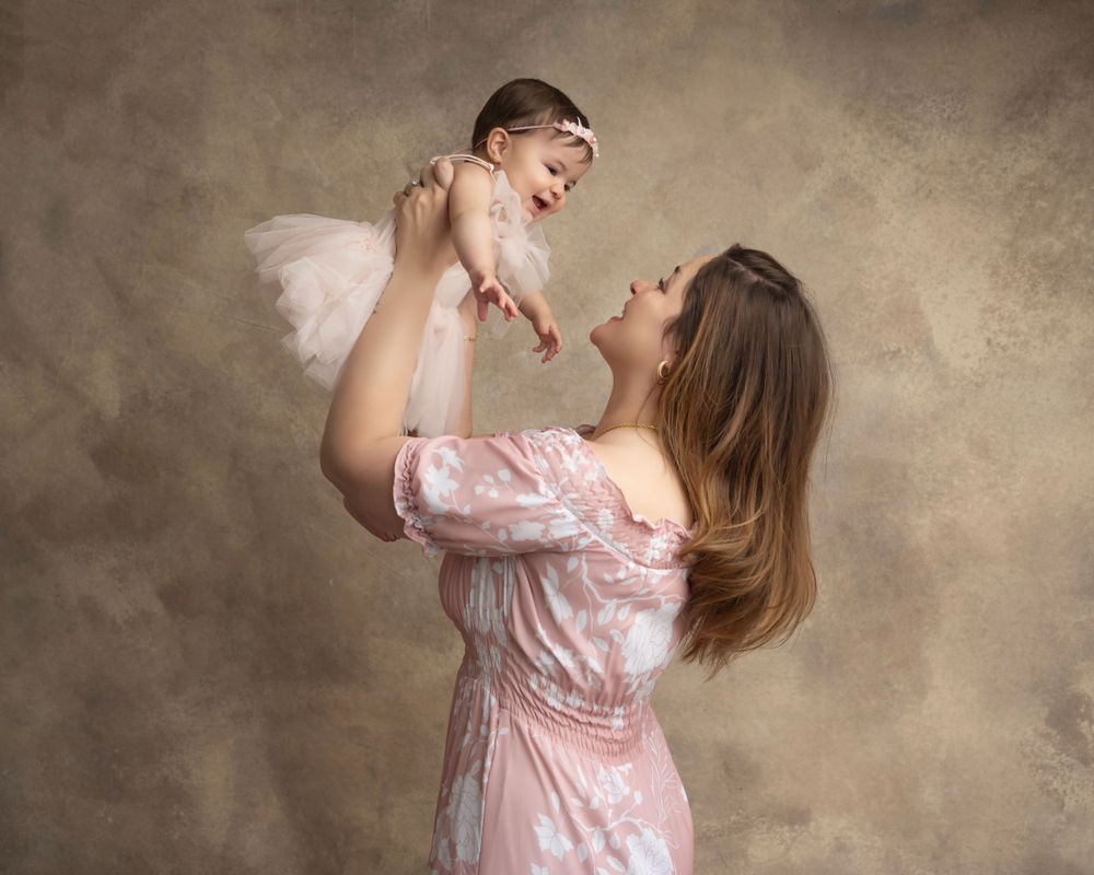 Beautiful series of loving family moments photographed in soft pink tones.