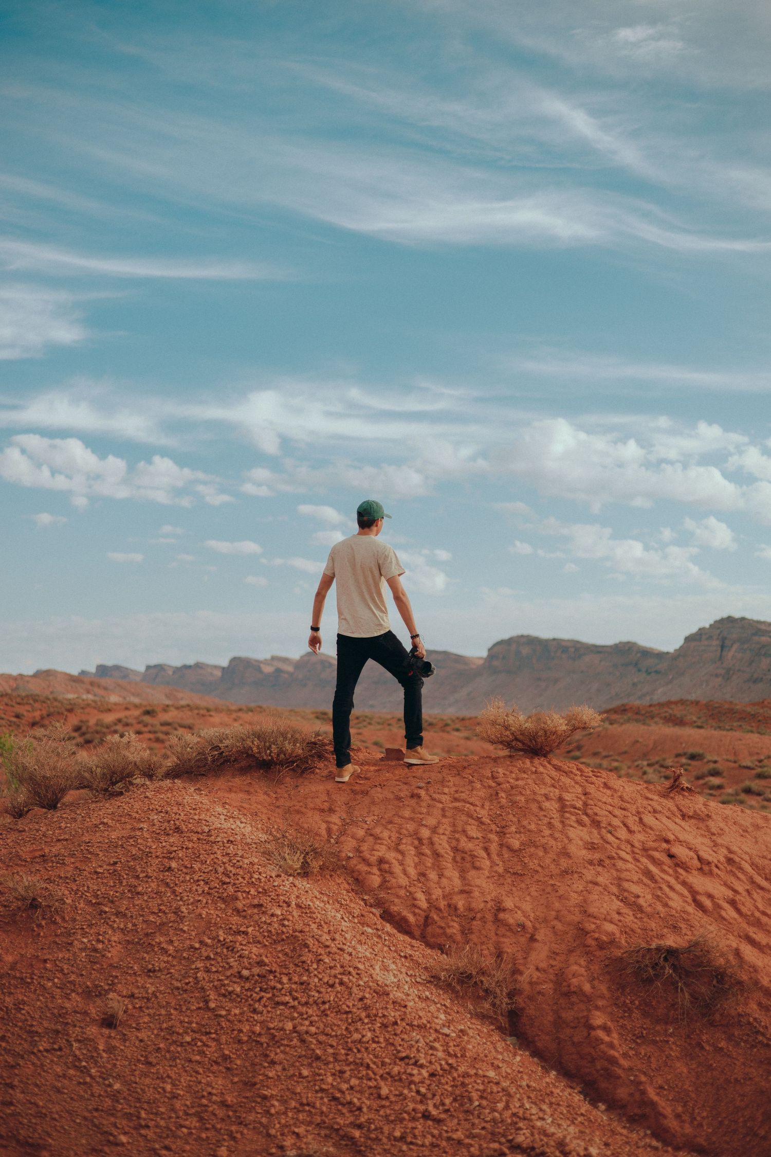 Cinematic outdoor portrait of Emmanuel Edel, Miami photographer, capturing storytelling visuals in red rock landscapes.