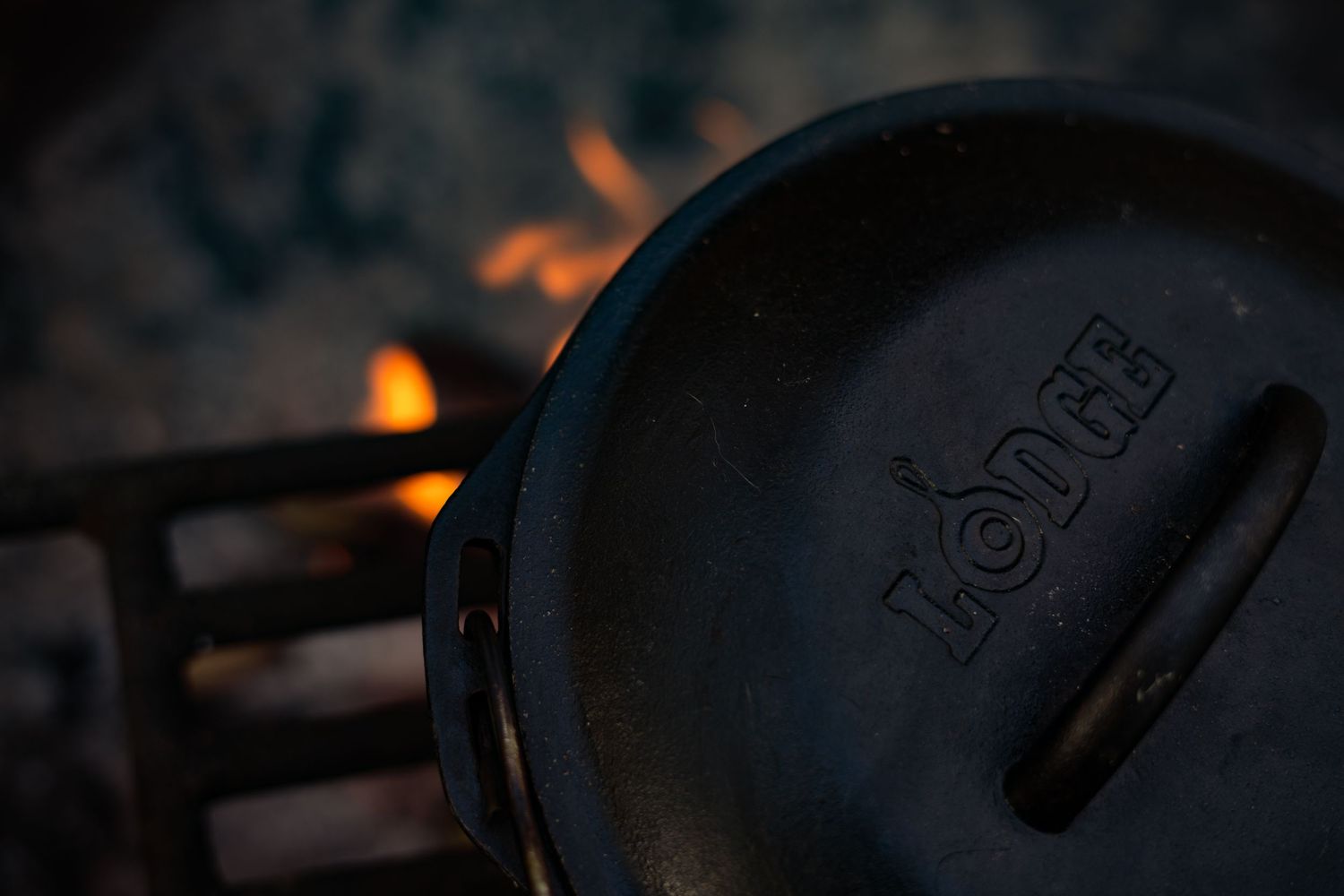 Lodge Dutch oven cooking over an open fire, perfect for outdoor camping meals.