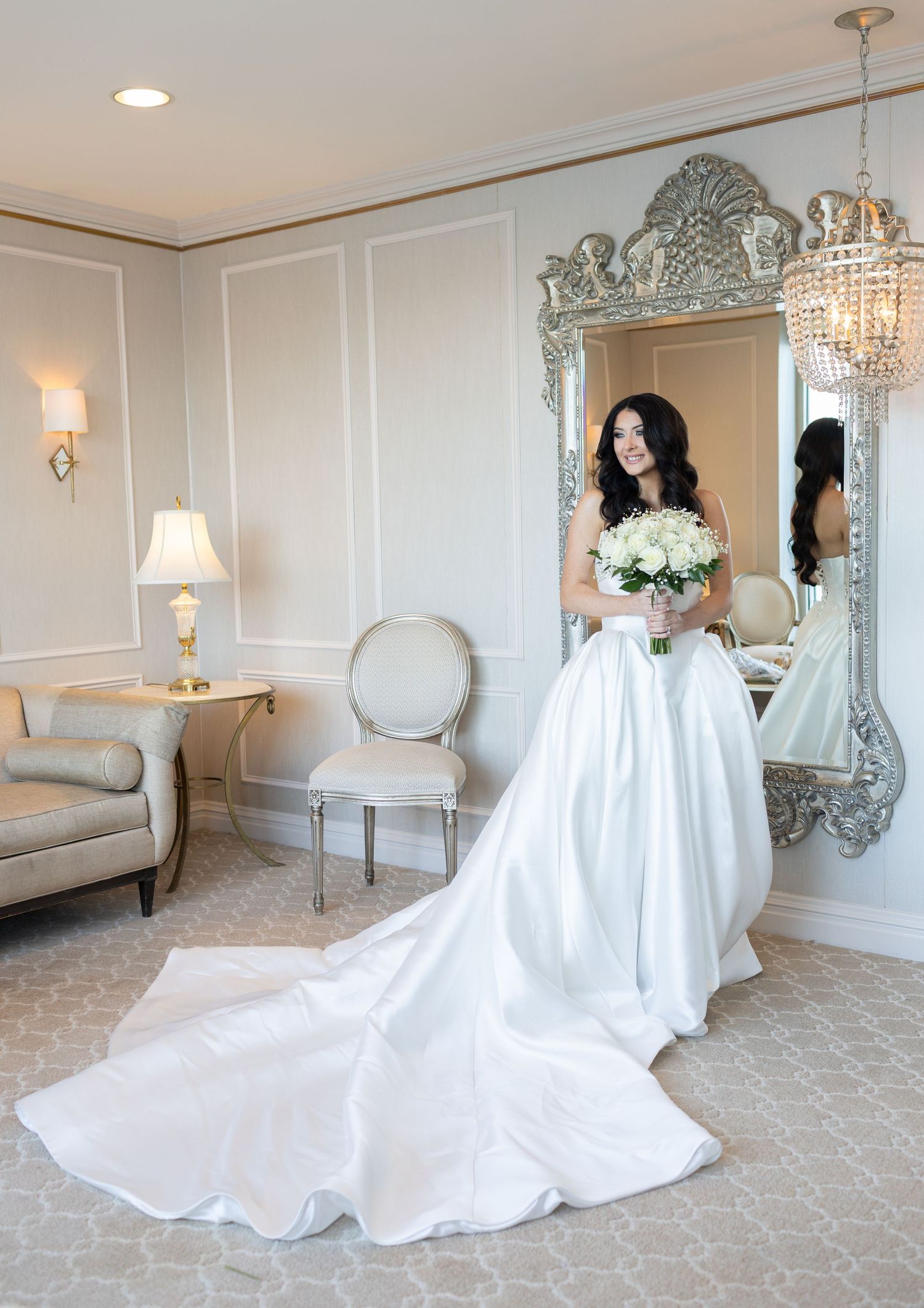 Bride holding bouquet in luxury bridal suite before Glen Island Harbour Club wedding.