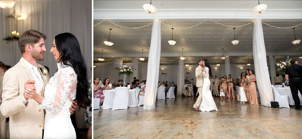 Bride and groom share their first dance in an elegant white ballroom with columns and wedding guests watching.