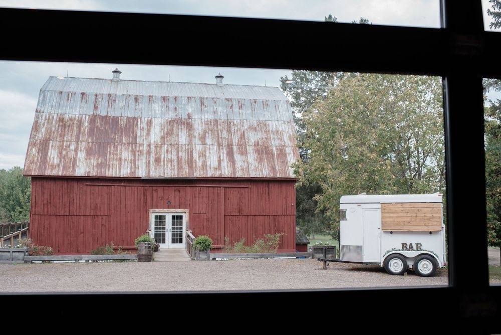 Red rustic barn with weathered siding and white trim photographed from different angles.