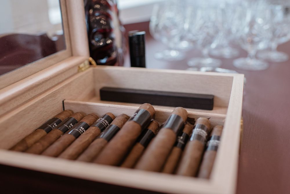 Close-up shot of premium cigars arranged in a wooden cigar box.