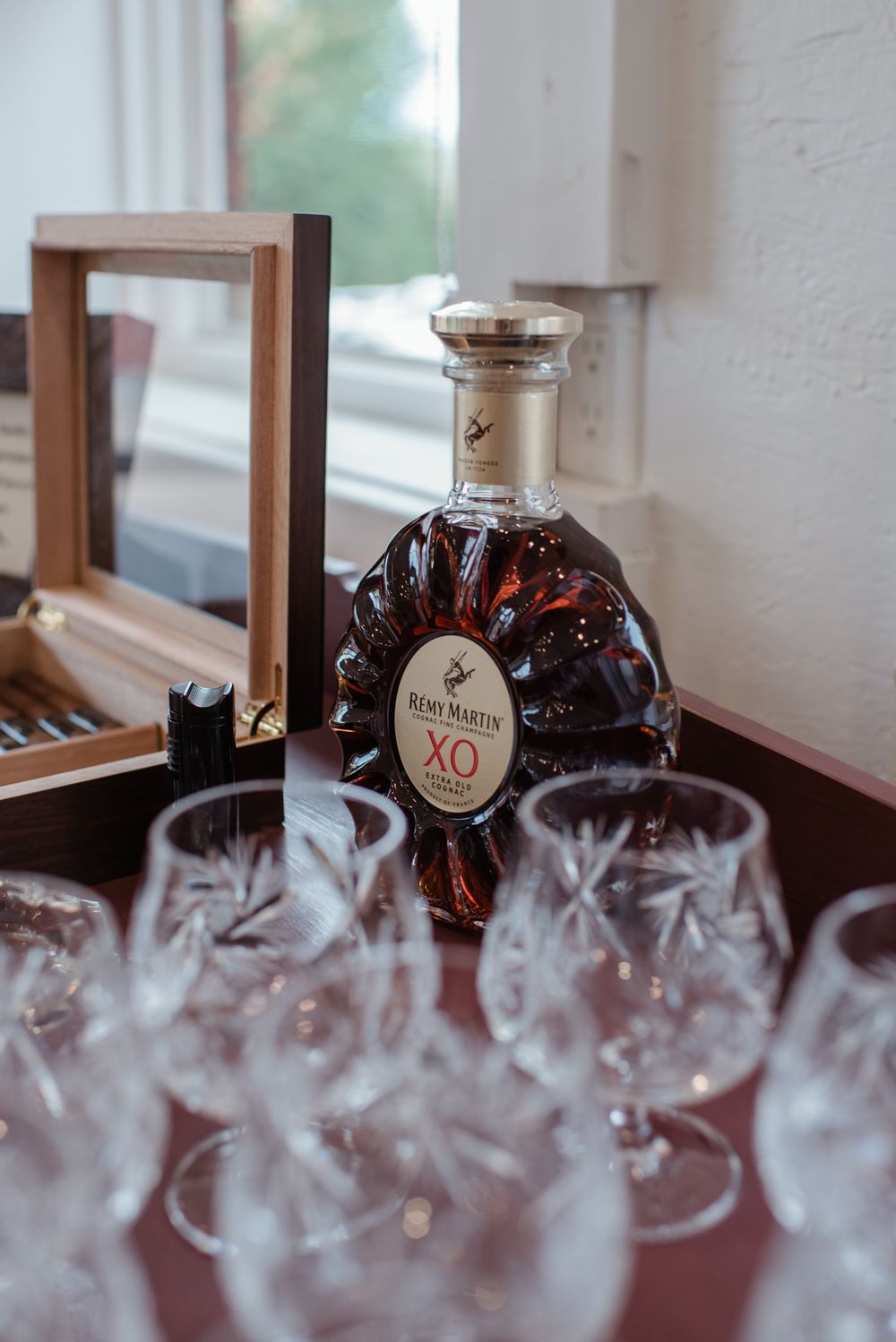 Bottles of aged spirits displayed in a foggy or misty atmosphere creating an elegant presentation.