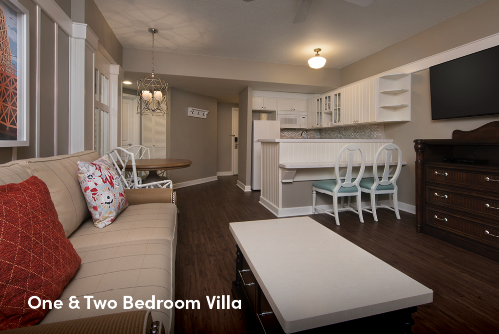Villa living area with kitchen bar, dining chairs, and comfortable seating.
