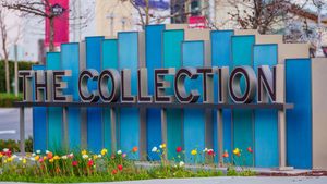 Colorful blue sign reading The Collection outdoors with tulips in foreground.