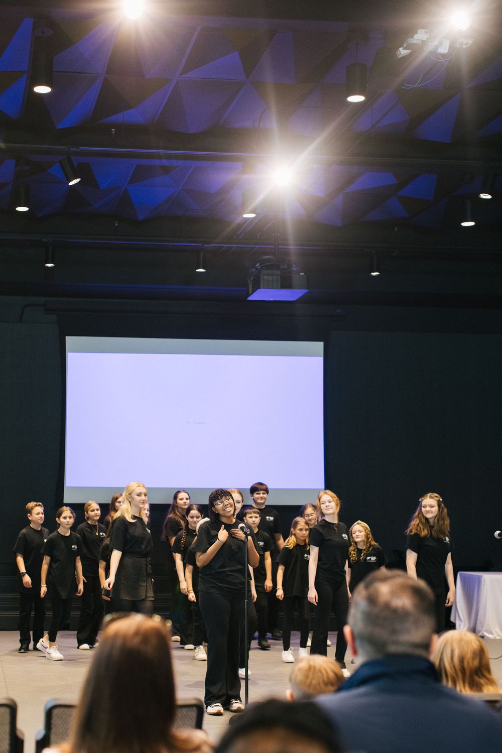 Corporate Event Photography in Lakeland, Florida. Children's performance in Black Box Theatre with Stage Light Flare