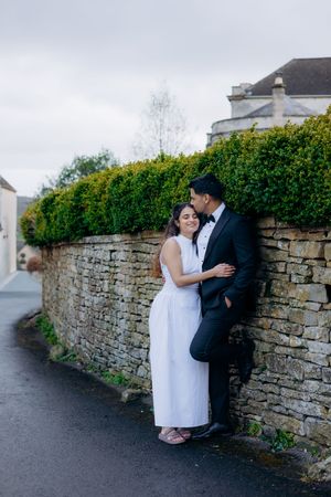 Cotswolds couple photography session in Painswick with historic stone buildings.