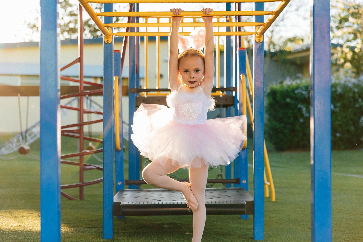 Little girl in dance costume in playground  during a professional photo shoot.