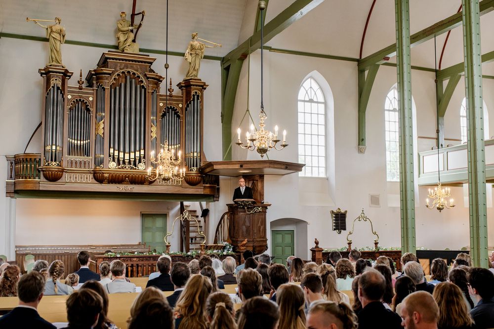 Bruid en bruidegom tijdens evangelische kerkdienst in Huizen