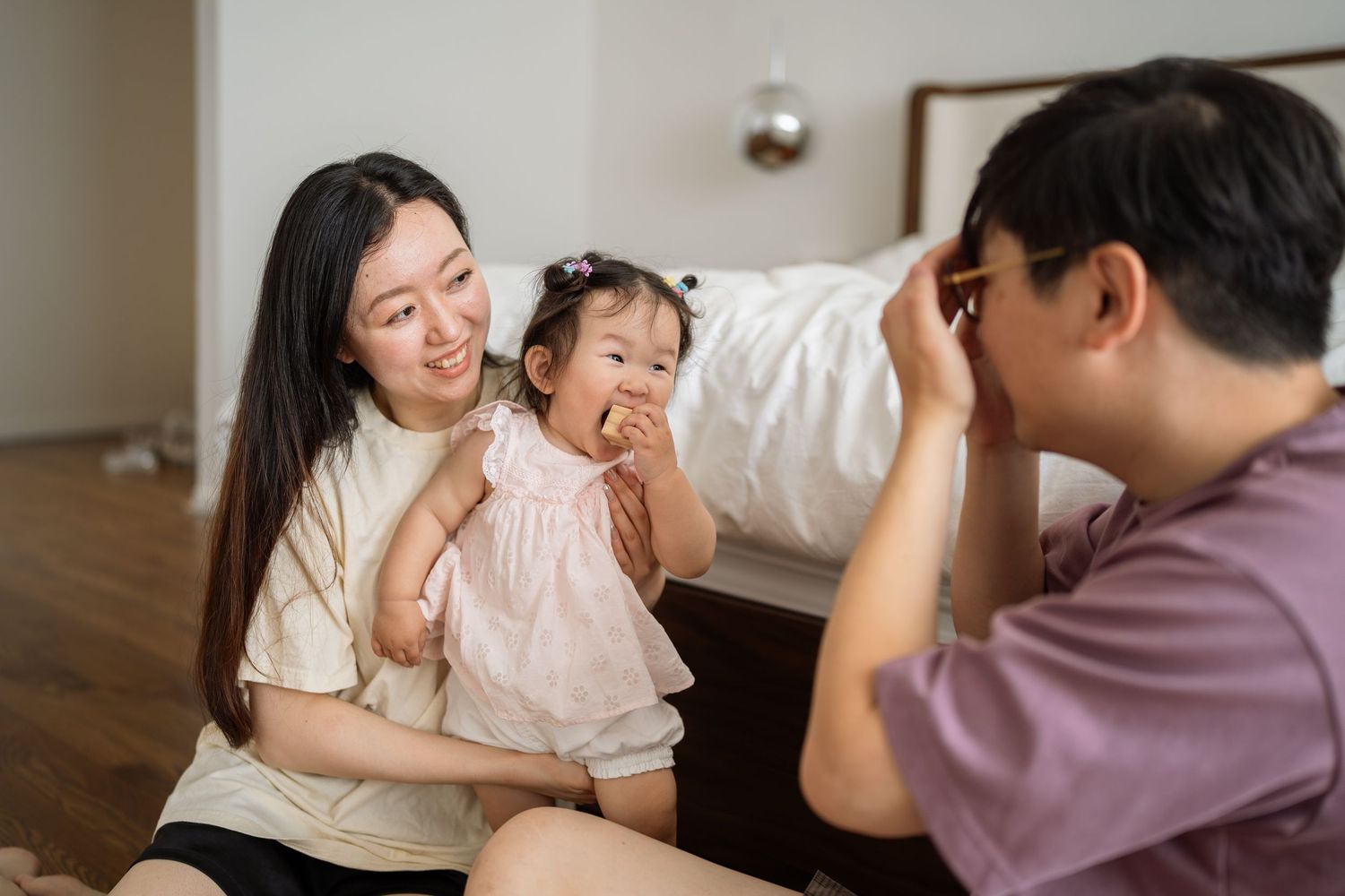 A series of tender family moments captured in warm indoor lighting showing parent and child interactions at home.
