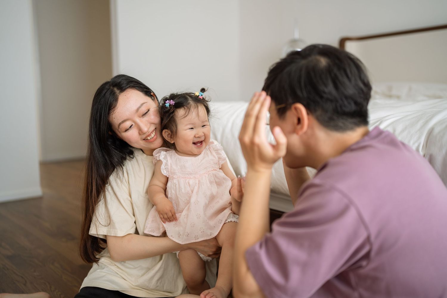 A family shares a joyful moment together while playing and laughing in their home.